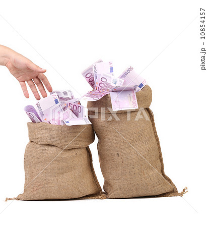 Hand to sacks with euro bills. 10854157
