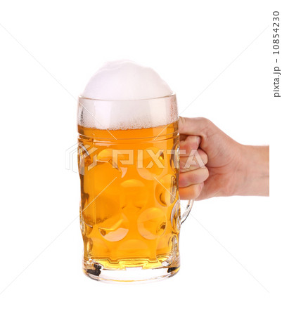 Mug of beer with foam in hand 10854230