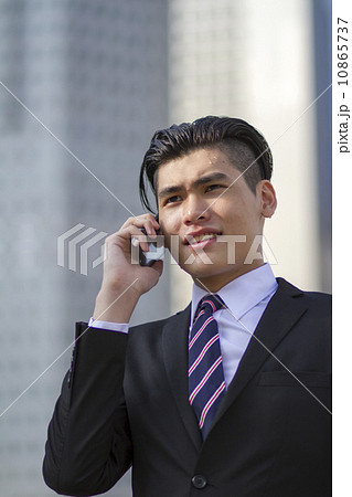 Young Asian businessman with mobile phone Young Asian businessman with mobile phone 10865737
