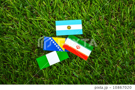 Paper cut of flags on grass for Soccer championship 2014 , group Paper cut of flags on grass for Soccer championship 2014 , group 10867020