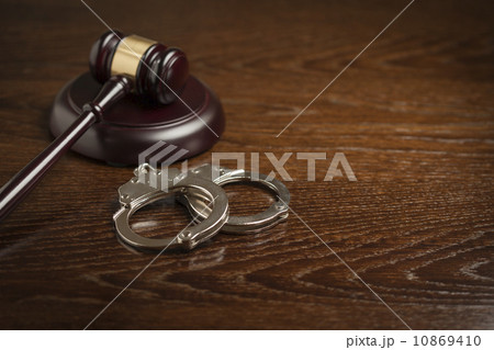 Gavel and Pair of Handcuffs on Table Gavel and Pair of Handcuffs on Table 10869410