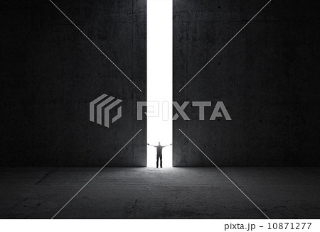 Dark abstract concrete interior. Man stands in the light of opening. Dark abstract concrete interior. Man stands in the light of opening. 10871277