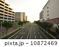 早朝の幹線道路と建物 10872469