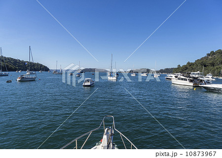A view of the bay from the yacht. There are many yachts anchored by the sea. 10873967