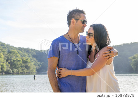A caucasian couple hugging and enjoying their time together by the beach. 10873979