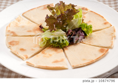 garlic pita bread pizza with salad on top 10874796