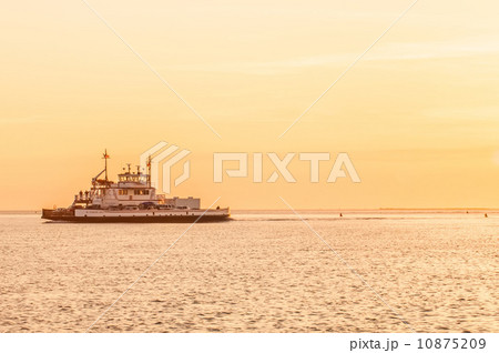 sunset on sea with ferry in distance 10875209