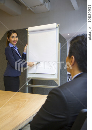 Young business executive giving a presentation to her colleague. Young business executive giving a presentation to her colleague. 10880931