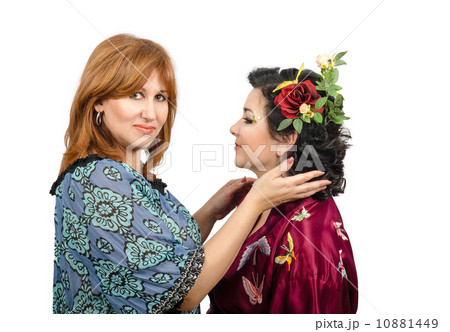 Hair stylist has made hairstyle with roses for her customer Hair stylist has made hairstyle with roses for her customer 10881449