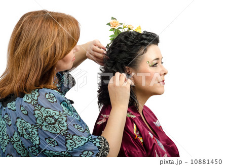 Red-haired hairdresser giving a new hairstyle to mature woman 10881450
