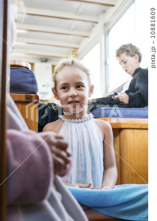 A caucasian little girl smiling for the camera in the Yacht. 10881609