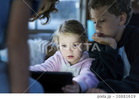 Caucasian children playing games on tablet computer Caucasian children playing games on tablet computer 10881619
