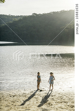 Two Caucasian girls running around by the beach, enjoying the sunset. Two Caucasian girls running around by the beach, enjoying the sunset. 10881636