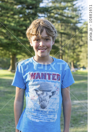 A Caucasian boy posing for the camera in the outdoors. A Caucasian boy posing for the camera in the outdoors. 10881651