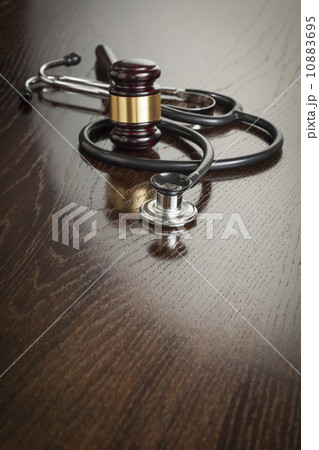 Gavel and Stethoscope on Reflective Table 10883695