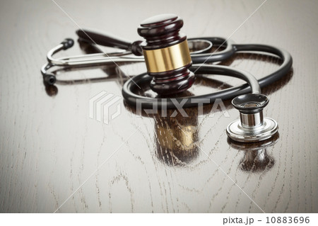 Gavel and Stethoscope on Reflective Table 10883696
