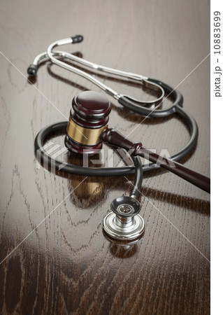 Gavel and Stethoscope on Reflective Table Gavel and Stethoscope on Reflective Table 10883699