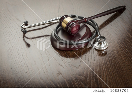 Gavel and Stethoscope on Reflective Table 10883702