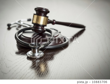 Gavel and Stethoscope on Reflective Table 10883706