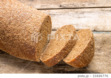 Rye bread laying on the old wood table. Rye bread laying on the old wood table. 10886776