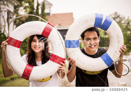 Lovely couple hold the life ring on the port3 Lovely couple hold the life ring on the port3 10888425