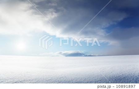 field of snow and cloudy sky 10891897