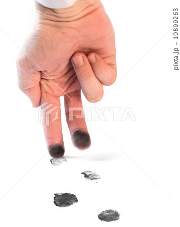 Stained fingers walking on the white sheet with black footprints. Fingerprints as a footprints 10899263