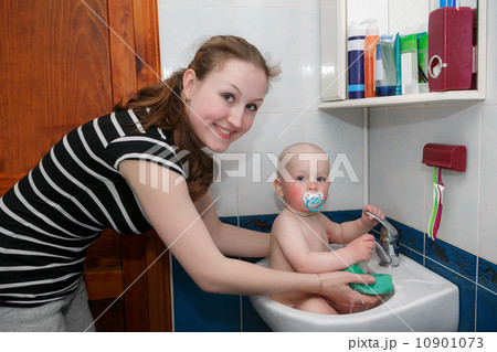 Sweet child taking a bath. 10901073