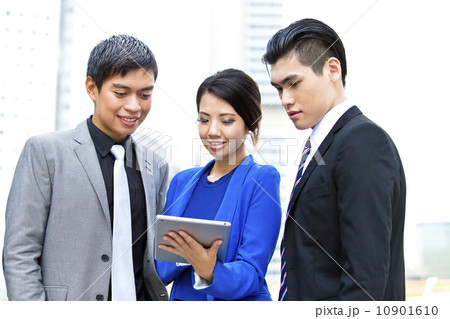 Three business office worker looking at tablet Three business office worker looking at tablet 10901610