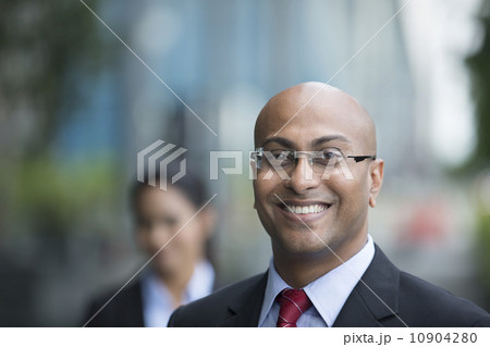 Indian business man and woman in a modern urban setting. 10904280