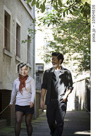 Two Asian friends walking outdoors relaxing. 10904636