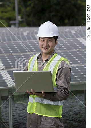 Asian engineers checking solar panel setup 10904748