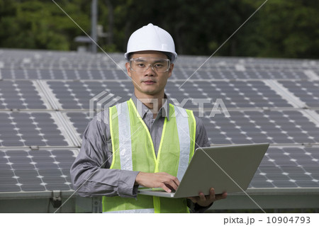 Asian engineers checking solar panel setup 10904793