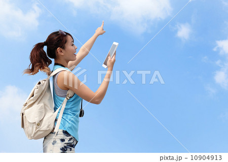 Happy woman traveler use tablet pc 10904913