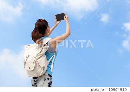 Happy woman traveler photo by tablet pc 10904919