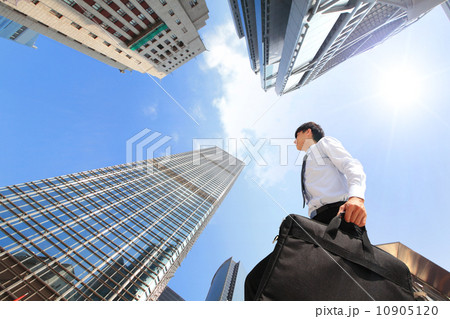 successful business man outdoors Next to Office Building 10905120