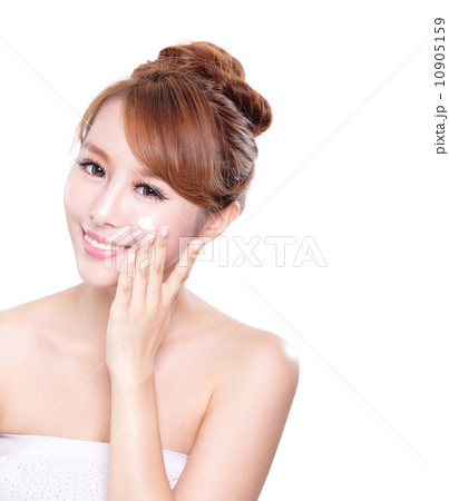 young woman applying moisturizer cream on face young woman applying moisturizer cream on face 10905159