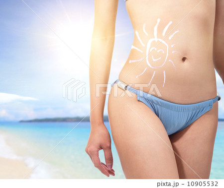young woman body at the beach with sun block cream 10905532