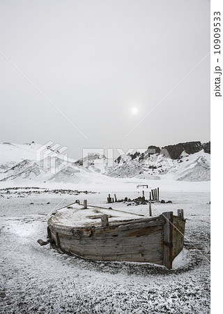 A wooden boat hull beached on Deception island, a former whaling station. A wooden boat hull beached on Deception island, a former whaling station. 10909533