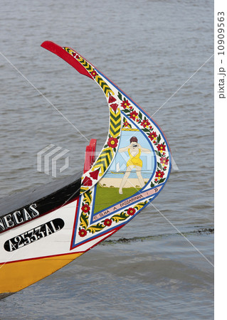 Traditional moliceiro fishing boat with a high prow, painted in vivid colours and with distinctive patterns. Traditional moliceiro fishing boat with a high prow, painted in vivid colours and with distinctive patterns. 10909563