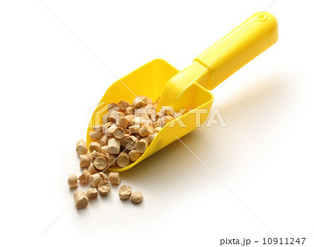 Wooden pellets on yellow shovel Wooden pellets on yellow shovel 10911247