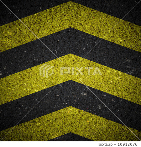 Yellow and black warning sign on asphalt texture 10912076