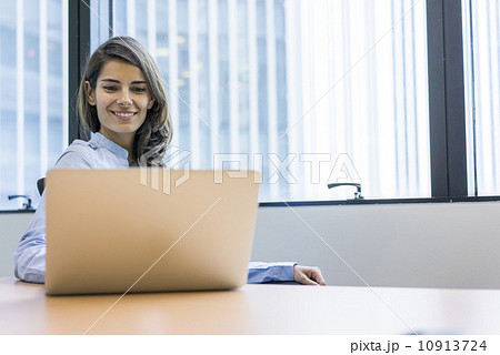 Asian executive in a working in the office on a laptop Asian executive in a working in the office on a laptop 10913724