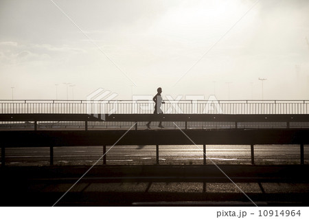 Jogging in a city. 10914964