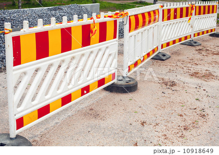 Striped red and yellow road barriers, area under construction Striped red and yellow road barriers, area under construction 10918649