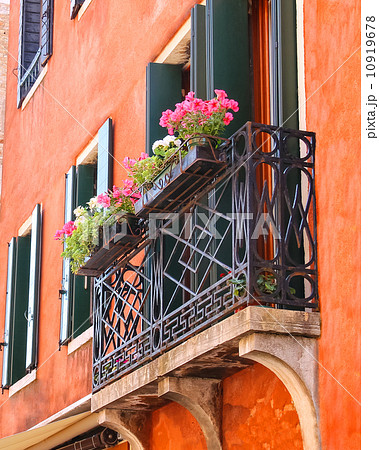 Picturesque balcony with flowers in an old Italian house 10919678
