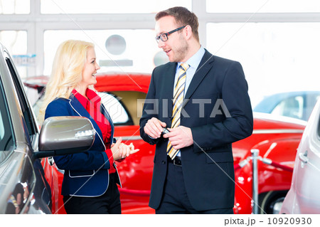 woman buying new car in auto dealership woman buying new car in auto dealership 10920930