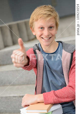 Successful student with books show thumb-up Successful student with books show thumb-up 10923054
