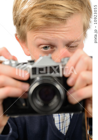 Teenage boy photographing through retro camera Teenage boy photographing through retro camera 10923055