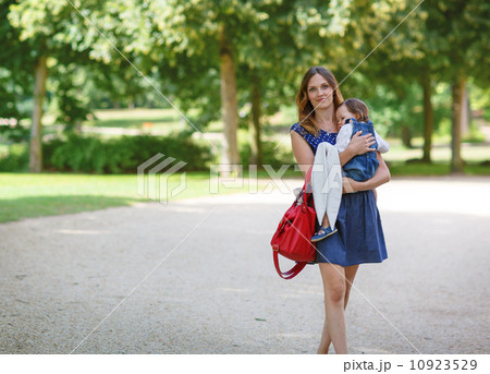 Beautiful mother and little daughter walking in summer park 10923529